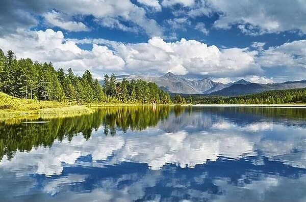 Beautiful mountain lake, still water, forest and reflection