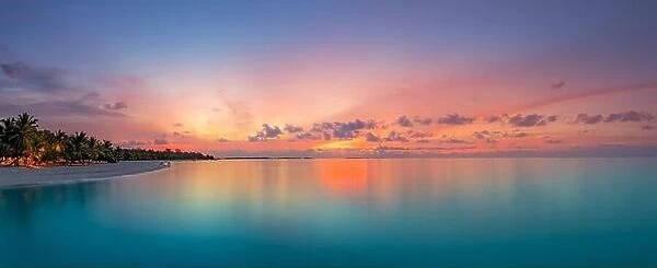 Beautiful panoramic sunset tropical paradise beach. Tranquil summer vacation or holiday landscape. Tropical sunset beach seaside palm calm sea pano