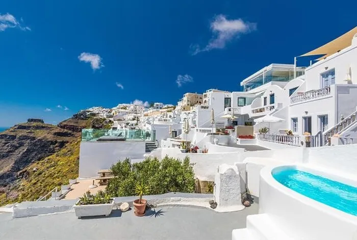 Framed Print : Beautiful panoramic view of picturesque town in Santorini, caldera and volcano on the Mediterranean Sea. Traditional white architecture holiday island