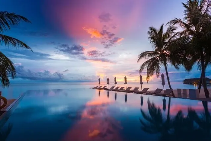 Framed Print : Beautiful poolside and sunset sky with palm trees. Luxury tropical beach landscape, infinity swimming pool, deck chairs and loungers under umbrella Framed Print : Beautiful poolside and sunset sky with palm trees. Luxury tropical beach landscape, infinity swimming pool, deck chairs and loungers under umbrella