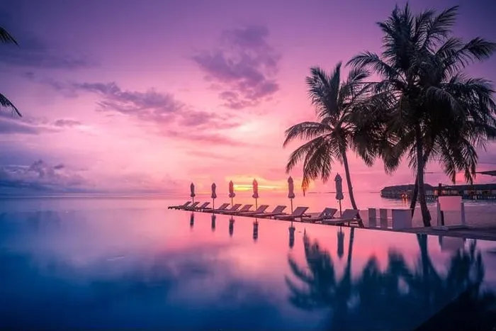 Framed Print : Beautiful poolside and sunset sky with palm trees. Luxury tropical beach landscape, infinity swimming pool, deck chairs and loungers under umbrella an Framed Print : Beautiful poolside and sunset sky with palm trees. Luxury tropical beach landscape, infinity swimming pool, deck chairs and loungers under umbrella an