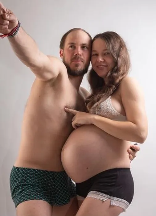 Framed Print : Beautiful pregnant woman and her handsome husband are kissing while spending time together in bed Framed Print : Beautiful pregnant woman and her handsome husband are kissing while spending time together in bed