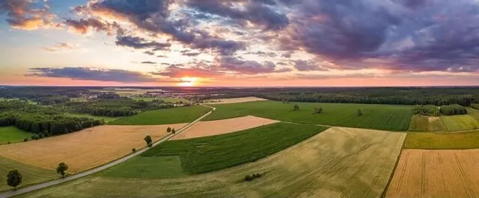 Framed Print : Beautiful summer fields landscape from drone. Sunset over fields and village Framed Print : Beautiful summer fields landscape from drone. Sunset over fields and village