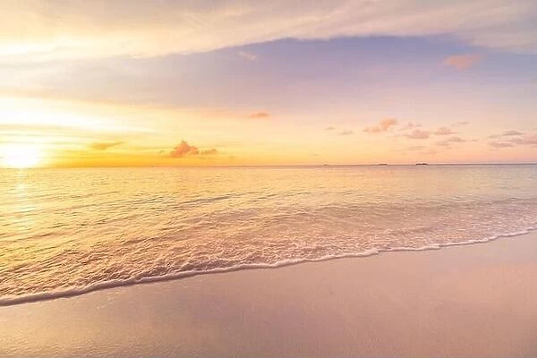 Beautiful sunset on the beach and sea. Tropical beach at beautiful sunset. Nature background. Exotic landscape, shore, coast, calm waves, soft sand