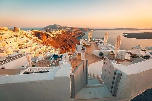 Beautiful sunset at Santorini island, Greece. Chairs on the terrace with sea view. Travel destinations concept. Summer vacation landscape