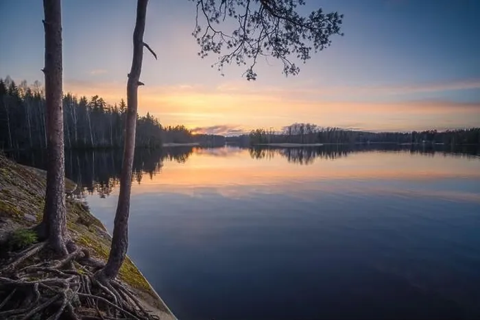 Framed Print : Beautiful sunset in tranquil lake at summer evening in Finland Framed Print : Beautiful sunset in tranquil lake at summer evening in Finland