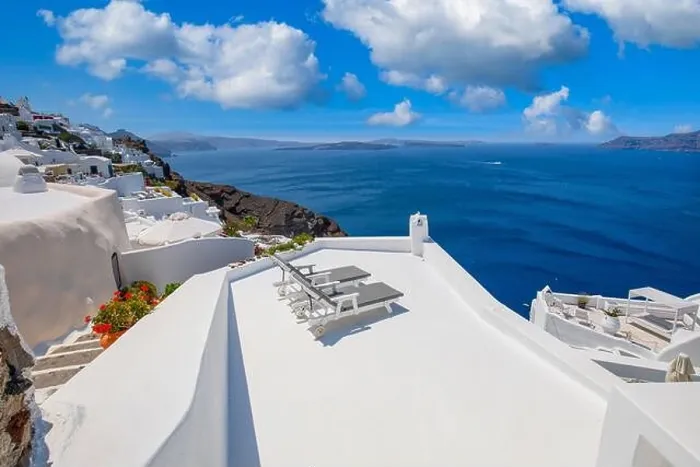 Framed Print : Beautiful travel background for vacation holiday banner. White houses in the town of Oia on the island of Santorini, panorama. Amazing scenic views