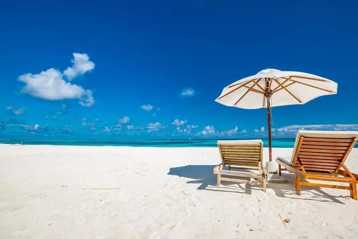 Framed Print : Beautiful tropical beach, two sun beds, loungers, umbrella under palm tree. White sand, sea view horizon, blue sky, calmness and relax resort scenery Framed Print : Beautiful tropical beach, two sun beds, loungers, umbrella under palm tree. White sand, sea view horizon, blue sky, calmness and relax resort scenery