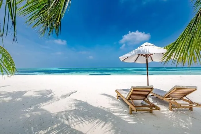 Framed Print : Beautiful tropical beach, two sun beds, loungers, umbrella under palm tree. White sand, sea view horizon, blue sky, calmness and relax resort scenery Framed Print : Beautiful tropical beach, two sun beds, loungers, umbrella under palm tree. White sand, sea view horizon, blue sky, calmness and relax resort scenery