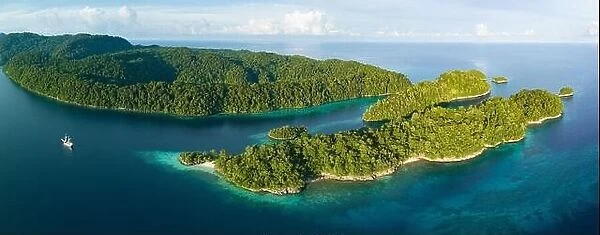 Beautiful tropical islands, surrounded by reefs, rise from West Papua's seascape. This area is known for its marine biodiversity