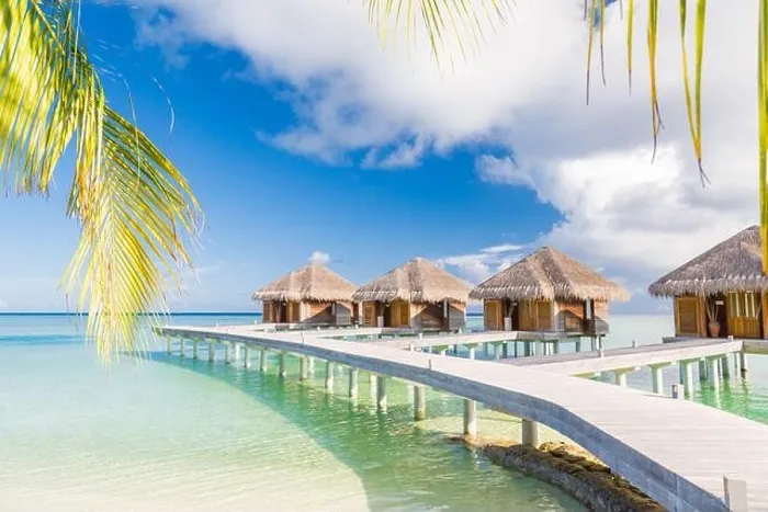 Framed Print : Beautiful tropical Maldives resort hotel water villas. Island with beach and palm leaves over sea on sky. Luxury holiday vacation background concept Framed Print : Beautiful tropical Maldives resort hotel water villas. Island with beach and palm leaves over sea on sky. Luxury holiday vacation background concept