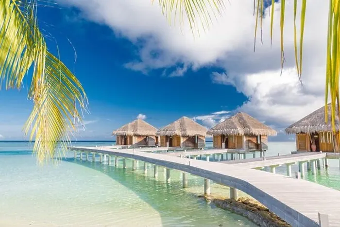 Framed Print : Beautiful tropical Maldives resort hotel water villas. Island with beach and palm leaves over sea on sky. Luxury holiday vacation background concept Framed Print : Beautiful tropical Maldives resort hotel water villas. Island with beach and palm leaves over sea on sky. Luxury holiday vacation background concept
