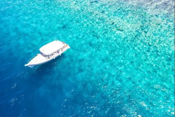 Framed Print : Beautiful turquoise ocean water boat top view aerial photo. Aerial view speed boat in the sea. Exotic sea lagoon, snorkel adventure, tropical ocean Framed Print : Beautiful turquoise ocean water boat top view aerial photo. Aerial view speed boat in the sea. Exotic sea lagoon, snorkel adventure, tropical ocean