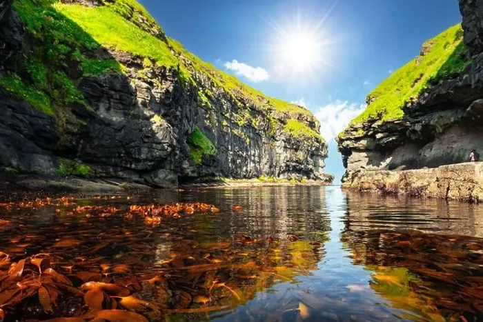 Framed Print : Beautiful view of dock or harbor with clear water and red seaweed in Gjogv village, Eysuroy island, Faroe Islands, Denmark. Landscape photography Framed Print : Beautiful view of dock or harbor with clear water and red seaweed in Gjogv village, Eysuroy island, Faroe Islands, Denmark. Landscape photography