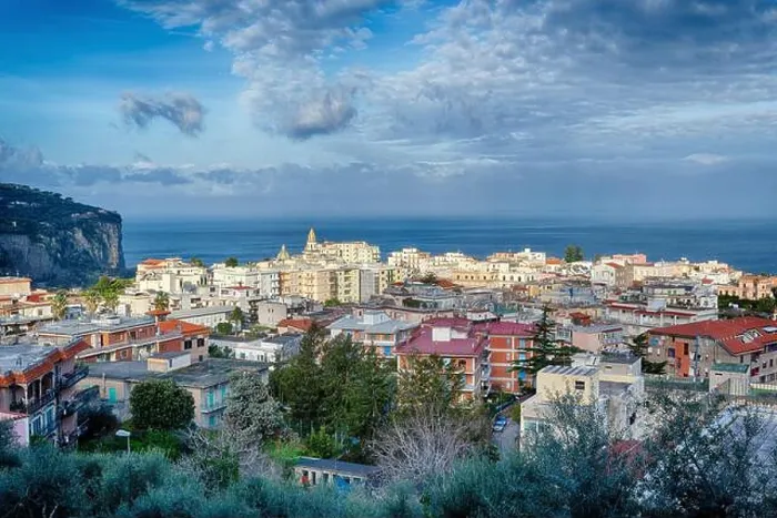 Framed Print : A beautiful view across the rooftops of vico equense and the bay of naples towards the island of ischia