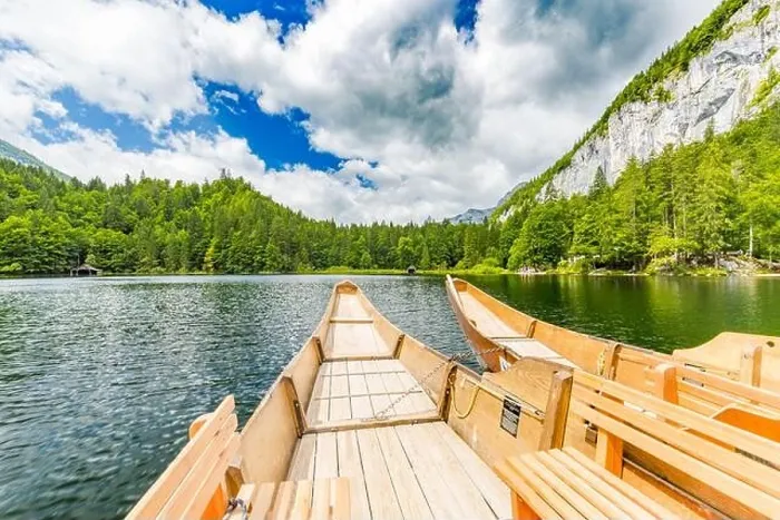 Framed Print : Beautiful view of traditional wooden rowing boat on scenic. Summer mountain lake pass scenic morning light at sunrise clouds over blue sky green trees