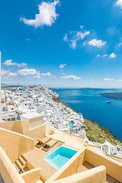 Beautiful white caldera view of Santorini in Greece. Luxury hotel resort pool over white architecture and sea view, blue sky. Summer travel vacation