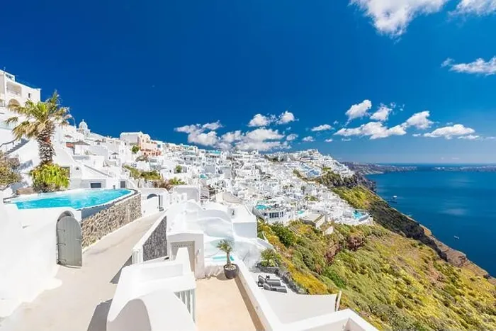Framed Print : Beautiful white caldera view of Santorini in Greece. Luxury hotel resort pool over white architecture and sea view, blue sky. Summer travel vacation Framed Print : Beautiful white caldera view of Santorini in Greece. Luxury hotel resort pool over white architecture and sea view, blue sky. Summer travel vacation