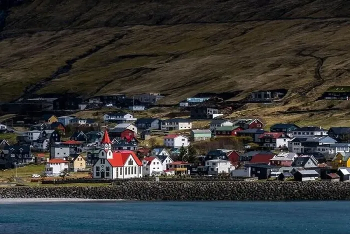 Framed Print : A beautiful white and red church in a small village in Faroe Islands Framed Print : A beautiful white and red church in a small village in Faroe Islands