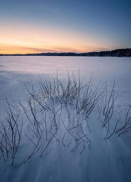 Beautiful winter landscape with snow and sunset at evening in Finland