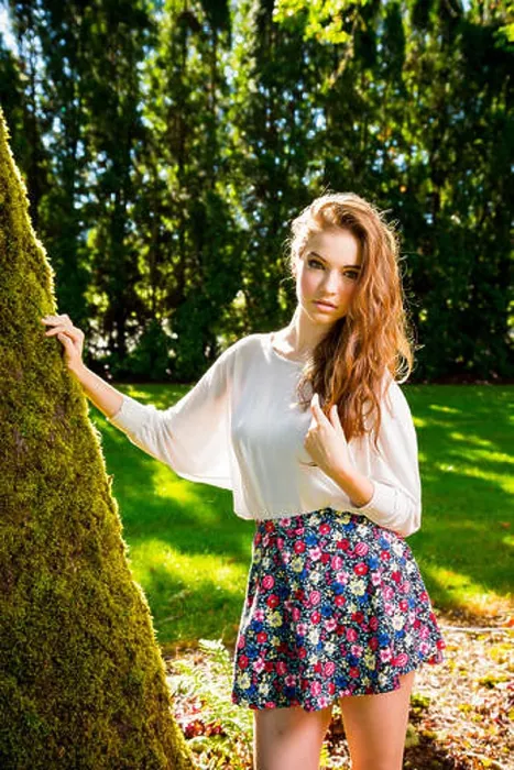 Framed Print : A beautiful young girl poses for a fashion style portrait outdoors at a park with natural lighting Framed Print : A beautiful young girl poses for a fashion style portrait outdoors at a park with natural lighting