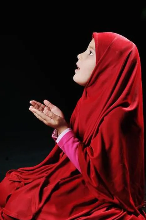Framed Print : Beautiful young muslim girl praying on black background Framed Print : Beautiful young muslim girl praying on black background