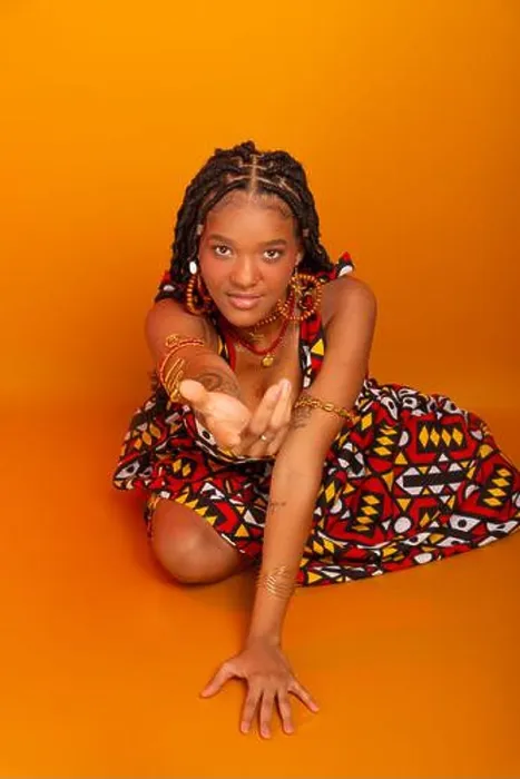 Framed Print : Beautiful young woman sitting with braids in her hair wearing traditional clothing Framed Print : Beautiful young woman sitting with braids in her hair wearing traditional clothing