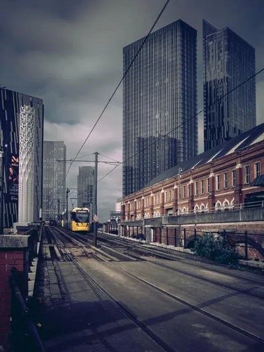 Framed Print : A Bee Network tram in Manchester against the backdrop of Deansgate Square tower skyscrapers with dark cloudy sky Framed Print : A Bee Network tram in Manchester against the backdrop of Deansgate Square tower skyscrapers with dark cloudy sky