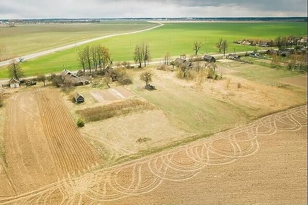 Belarus. Aerial View Of Belarusian Village. Beautiful Rural Landscape In Bird's-eye View. Beginning Of Agricultural Spring Season. Tracks On Plowed