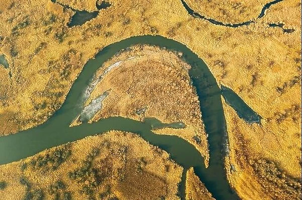 Belarus. Aerial View Of Dry Grass And Partly Frozen Curved River Landscape In Late Autumn Day. High Attitude View. Marsh Bog. Drone View. Bird's Eye V