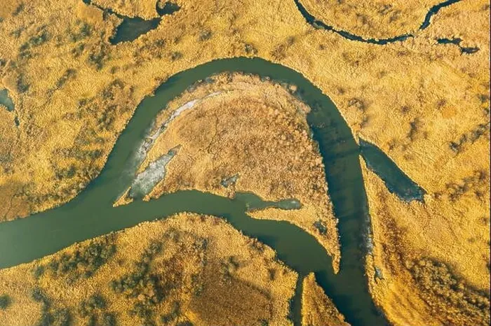 Framed Print : Belarus. Aerial View Of Dry Grass And Partly Frozen Curved River Landscape In Late Autumn Day. High Attitude View. Marsh Bog. Drone View. Bird's Eye V Framed Print : Belarus. Aerial View Of Dry Grass And Partly Frozen Curved River Landscape In Late Autumn Day. High Attitude View. Marsh Bog. Drone View. Bird's Eye V