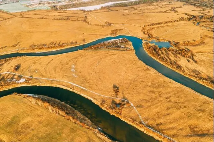 Framed Print : Belarus. Aerial View Of Dry Grass And Partly Frozen Curved River Landscape In Late Autumn Day. High Attitude View. Marsh Bog. Drone View. Bird's Eye V Framed Print : Belarus. Aerial View Of Dry Grass And Partly Frozen Curved River Landscape In Late Autumn Day. High Attitude View. Marsh Bog. Drone View. Bird's Eye V