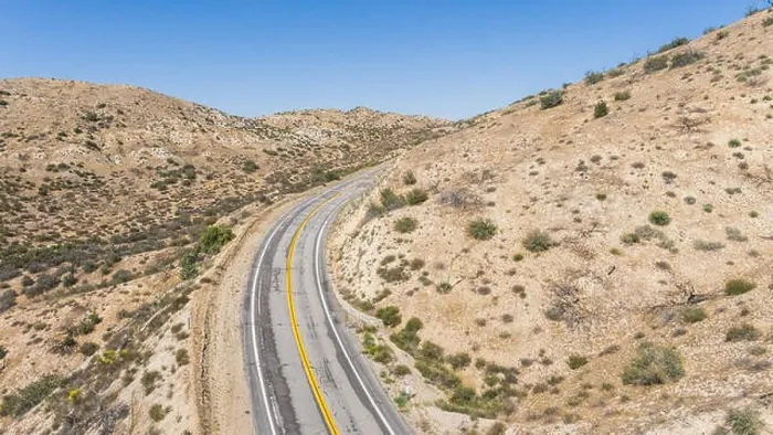 Framed Print : Bend in a desert road wrapping around a wilderness hillside Framed Print : Bend in a desert road wrapping around a wilderness hillside