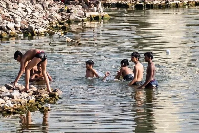 Framed Print : Bhopal, Madhya Pradesh, India - March 2019: Young Indian teenage boys swimming and bathing in the waters of the Upper Lake in the city of Bhopal Framed Print : Bhopal, Madhya Pradesh, India - March 2019: Young Indian teenage boys swimming and bathing in the waters of the Upper Lake in the city of Bhopal