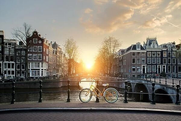 Bicycles lining a bridge over the canals of Amsterdam, Netherlands. Bicycle is major form of transportation in Amsterdam, Netherlands