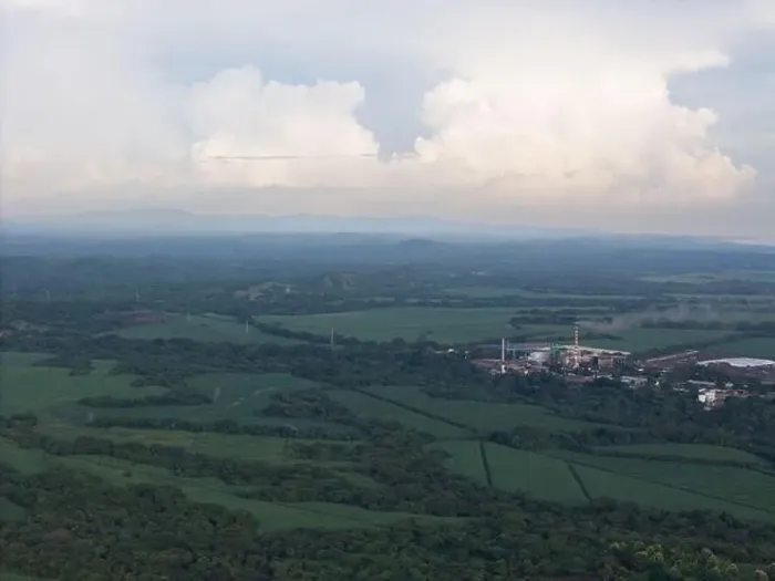 Framed Print : Big factory with tall smokey chimney on green landscape aerial drone view