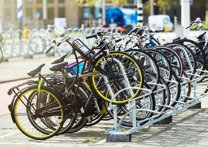 Framed Print : Many bikes parked in the street. Different used bicycles on parking lot. Healthy city transport in Netherlands Framed Print : Many bikes parked in the street. Different used bicycles on parking lot. Healthy city transport in Netherlands