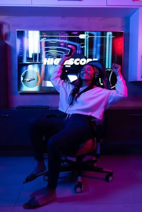 Framed Print : A biracial young female wearing white hoodie, playing video games at home Framed Print : A biracial young female wearing white hoodie, playing video games at home