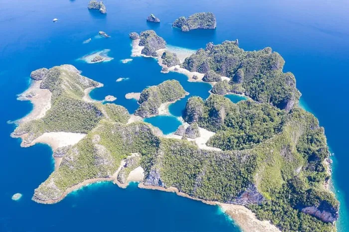 Framed Print : A bird's eye view shows healthy reefs surrounding remote limestone islands in Raja Ampat. This area is known for its incredible marine biodiversity Framed Print : A bird's eye view shows healthy reefs surrounding remote limestone islands in Raja Ampat. This area is known for its incredible marine biodiversity