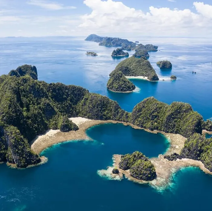Framed Print : A bird's eye view shows healthy reefs surrounding remote limestone islands in Raja Ampat. This area is known for its incredible marine biodiversity Framed Print : A bird's eye view shows healthy reefs surrounding remote limestone islands in Raja Ampat. This area is known for its incredible marine biodiversity