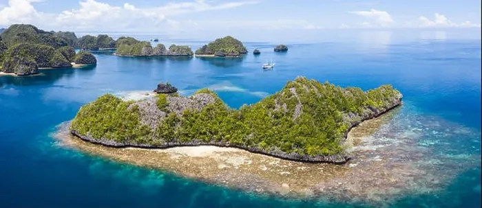 Framed Print : A bird's eye view shows healthy reefs surrounding remote limestone islands in Raja Ampat. This area is known for its incredible marine biodiversity Framed Print : A bird's eye view shows healthy reefs surrounding remote limestone islands in Raja Ampat. This area is known for its incredible marine biodiversity