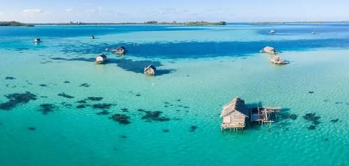 Framed Print : A bird's eye view shows a rustic Indonesian fishing village constructed on a coral reef near remote, tropical islands in the Halmahera Sea Framed Print : A bird's eye view shows a rustic Indonesian fishing village constructed on a coral reef near remote, tropical islands in the Halmahera Sea