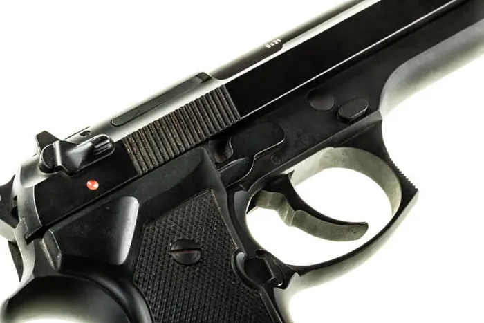 Framed Print : detail of a black 9mm pistol isolated over a white background Framed Print : detail of a black 9mm pistol isolated over a white background