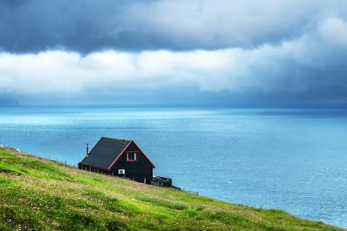 Framed Print : Black house on famous faroese Witches Finger Trail Framed Print : Black house on famous faroese Witches Finger Trail