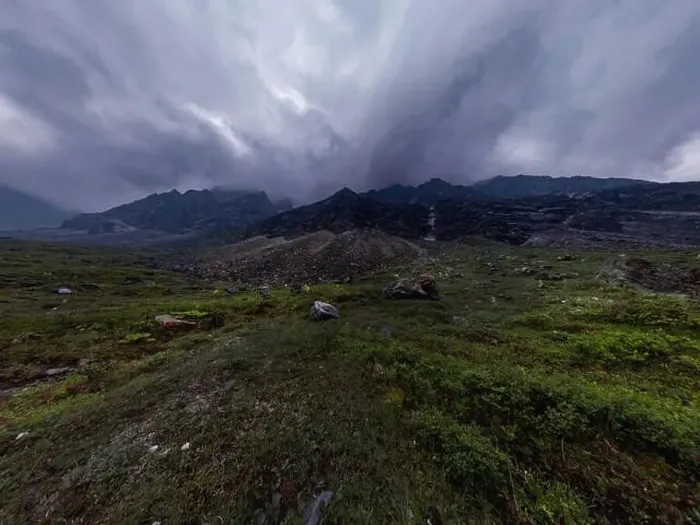 Framed Print : Black mountains in rain clouds, the foot covered with stones and green grass. Wide angle panorama Framed Print : Black mountains in rain clouds, the foot covered with stones and green grass. Wide angle panorama