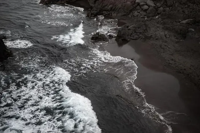 Framed Print : Black sand beach aerial view. Small volcanic rocks and graphic diagonal waves Framed Print : Black sand beach aerial view. Small volcanic rocks and graphic diagonal waves