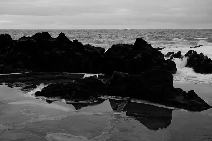 Framed Print : Black volcanic rocks reflect in shallow water against the backdrop of the Atlantic at Porto Moniz natural pools Framed Print : Black volcanic rocks reflect in shallow water against the backdrop of the Atlantic at Porto Moniz natural pools