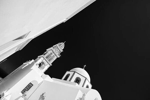 Black and white image of church in Santorini Oia, Greece. Abstract monochrome photo, white architecture under dark sky. Artistic background