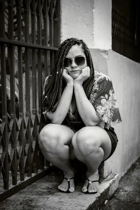 Framed Print : Black and white portrait of a woman wearing sunglasses crouching down looking at the camera with her hands on her chin. Pelourinho, Brazil Framed Print : Black and white portrait of a woman wearing sunglasses crouching down looking at the camera with her hands on her chin. Pelourinho, Brazil