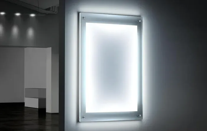 Framed Print : Blank white illuminated poster mockup in dark hall